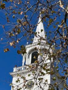 Washington CT church tower with leaves in the foreground
